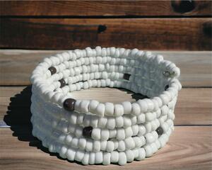 white five-tiered memory wire bracelet made with glass seed beads.