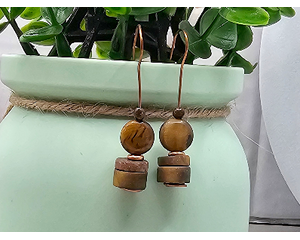 These tiger eye rondelle and coin beads are hung on unique hand made copper earring wires. They are about 1 and a half inches long.