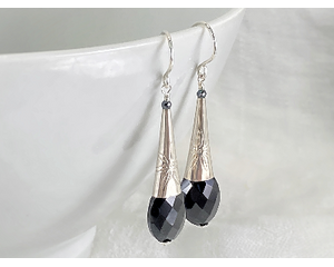 Elegant faceted black spinel earrings with sterling silver cones and ear wires.