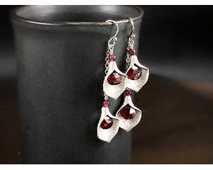 Garnet and rhodium-plated dangle calla lily earrings.