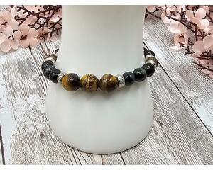This handcrafted stretch bracelet is comprised of blue tiger eye, yellow tiger eye, and pewter beads. This bracelet is about 7 inches.