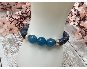 This stretch bracelet combines blue dyed quartz and porcelain beads. This bracelet is about 6 and a half inches.