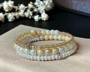 Pearl wrap bracelet on memory wire. The colors are neutral, so can be worn as a wedding bracelet