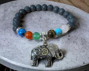 Elephant charm on glass beads and lava rock stone beads. stretch cord.
