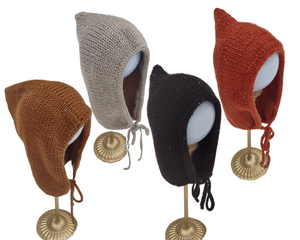 Handknit Baby Bonnet with seamless design for sensory considerations ties under the chin. Has a rounded edge. Colors include Cognac, Beige, Black, and Rust. Sizes 0-3 Months to 18-24 Months.