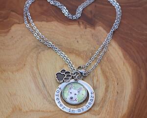 Silver chain link necklace featuring a white dog charm, Forever in my heart, and paw print acccent charms.