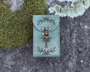 This Premium Handmade Leather Tarot Card Case features a luna moth, crescent moon, antlers and flowers.