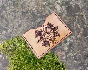 This is a truly handmade wallet featuring the pointer glyph from the Aztec calendar -- hand cut, tooled and stitched. Crafted from ultra durable vegetable tanned leather