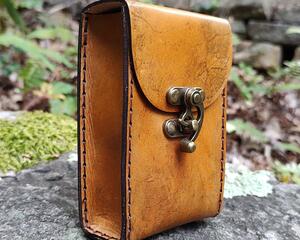 Premium Handmade Leather Tarot Card Case which has been specially sized to fit slightly smaller (palm sized) tarot decks. It's been hand dyed in Amber Tan and hand sewn in Espresso Brown. There is incredible depth in the color - many shades of amber, tan, browns, and blacks completely cover this case