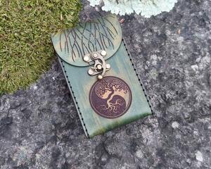 This is a Premium Handmade Leather Tarot Card Case in beautiful shades of green, featuring a Tree of Life Balance symbol on the front. The back of the case features a larger Tree of Life with branches extending over the top and the front flap of the case. This special leather tarot card box was hand dyed and hand sewn in our shop.

Hand crafted from vegetable tanned (naturally tanned) leather. We use full grain leather which retains the full richness and character of the hide. Vegetable tanned leather will develop a wonderful patina with use. The case is designed to last decades and improve with age and use.

This special and unique find would make a beautiful gift for a tarot enthusiast in your life, or anybody looking to protect their tarot cards, oracle decks, or other small items. 

Featuring artwork permanently etched into the leather in black:

The front of this leather case displays the Tree of Life as a balance symbol.
The back of the case features a large Tree of Life with branches which extend over the front.