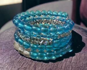 This beautiful handmade blue bracelet has 5 round of glass beads.