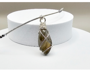 20 inch necklace features a labradorite cabochon wrapped using tarnish resistant silver artistic wire on stainless steel french bullion cord