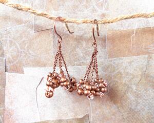 This pair of earrings has twisted antique copper colored wire with bronze colored glass beads and seed beads at the bottom. The earring hooks are handmade and also antique copper colored wire.