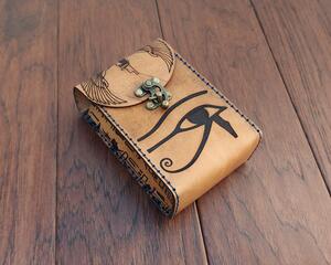 Oversized to fit slightly larger tarot decks, this premium handmade leather tarot card case features an ancient Egyptian motif. The Eye of Horus, Thoth, Winged Isis and snippets of heiroglyphs from the Book of the Dead are all included.