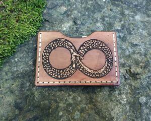 handmade wallet featuring the Ouroboros symbol in warm brown with ivory stitching