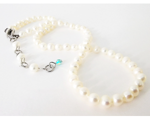 Hand knotted creamy white pearl choker necklace with extender chain, accented with a blue crystal.
