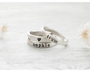 Free formed organic shaped sterling silver ring stamped with name and hearts. 