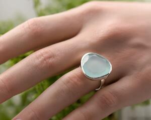Sterling silver ring with a 18mm  free form chalcedony faceted stone with a sterling silver bezel and narrow 3mm band.