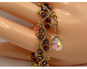 Purple Bicone Crystal and Gold tone Miyuki Seed Beads in a beautifully handmade, woven, unique and sparkly bracelet. A perfect gift!