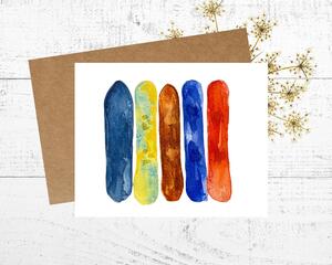 Greeting card with watercolor snowboards of yellow, blue, brown orange.