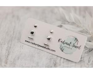 Minimalist sterling silver stud earrings (dot, square, bar) on a Radiant Jewel Studio card, with soft background. 

