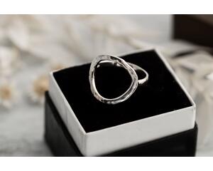 Sterling silver ring with an open circle top, lightly hammered textured finish. 