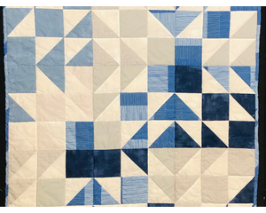 Blue, tan and white baby quilt
