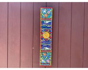 7.5 x 37 inch mosaic Totum. Bright colors with a big yellow sunburst in the center. Seagulls flying, starfish and waves. One of a kind Art.