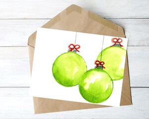 Watercolor painting of three light green round holiday ornaments. They are topped with a small red bow, hanging on a string. 
