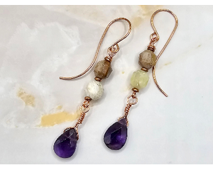 Earrings with yellow opal on wire and deep purple wire wrapped amethyst briolette dangles. On handcrafted copper earring wires.