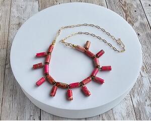 bib necklace on gold chain, vibrant ruby impression jasper barrel beads and brass accents, every other bead dangles perpendicularly on wire 