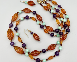Double-strand necklace — graduated strand of Czech 1920s amber glass ovals, amethyst, and Burma jade
