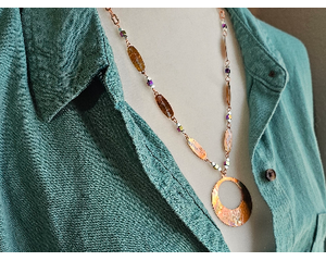 Necklace with off-center copper washer pendant and copper ovals, all textured and flame colored to add sparkle and color on copper chain
