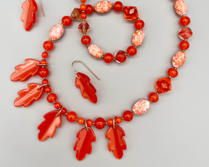 Necklace set | Mid-century vintage orange Lucite oak leaves, glass beads, and crystals