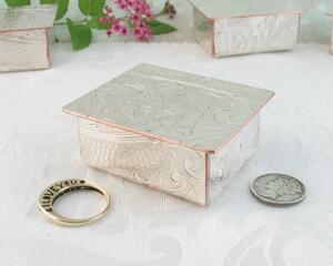 photo of small trinket box hand made from a vintage silverplated copper tray. photo shows a dime and my I Love You ring for size comparison.
