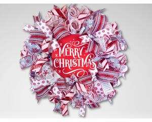 Handmade rustic Christmas wreath with red and white ribbons, snowflake accents, and farmhouse holiday decor on a white background.