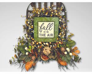 Rustic fall tobacco basket wreath with berries, greenery, and a 'Fall Is In The Air' sign. Perfect for farmhouse autumn door decor.