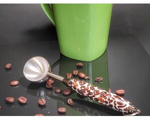 Barista coffee scoop with a stainless steel bowl and a coffee bean-infused resin handle.