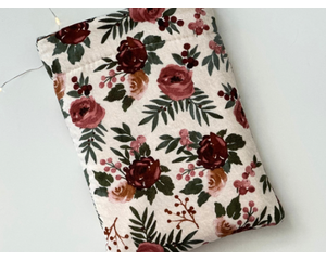 this floral book sleeve has a light brown background with different shades of brown flowers & the leaves are dark green