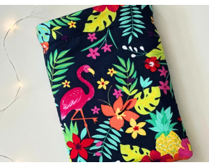 This tropical book sleeve has navy background with flamingos, tropical leaves and flowers in bright colors