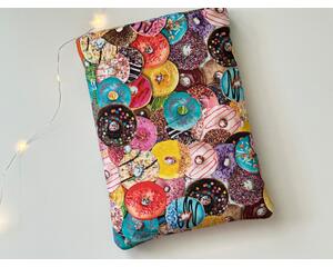 This donut book sleeve has colorful donuts all over the book jacket with different designs on all of the donuts
