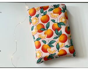 This citrus orange book sleeve has a light pink background with tiny white polka dots. Some oranges is full with leaves with flowers and others are cut open