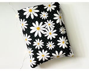 This daisy book sleeve has a black background with tiny white polka dots, and different sizes of flowers
