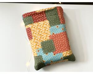 this patchwork book sleeve has fall colors blocks with each color having different prints