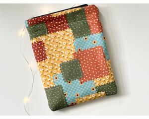 this fall patchwork tablet sleeve has fall colors yellow, orange, blue, red & green each block having different prints