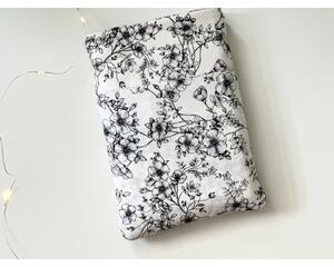 this floral book sleeve has a white background with black floral