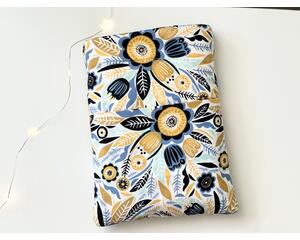 this floral book sleeve has a white background with navy, blue and gold flowers and leaves