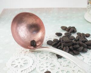 Photo of a Hand hammered copper coffee measuring spoon with a handle made from an antique silverplate fork of the pattern called "Heraldic", PATENTED 1916.