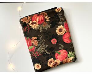 this fall tablet sleeve has a brown background with pumpkins and sunflowers having a bit of gold sparkly outline