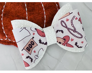 Off white glitter and faux leather print Halloween cowgirl western design hair bow. Bow is sold individually.